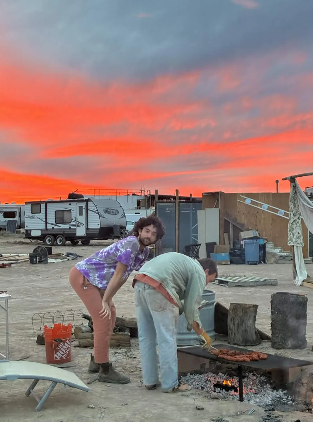 Grilling dinner under a fiery sunset sky